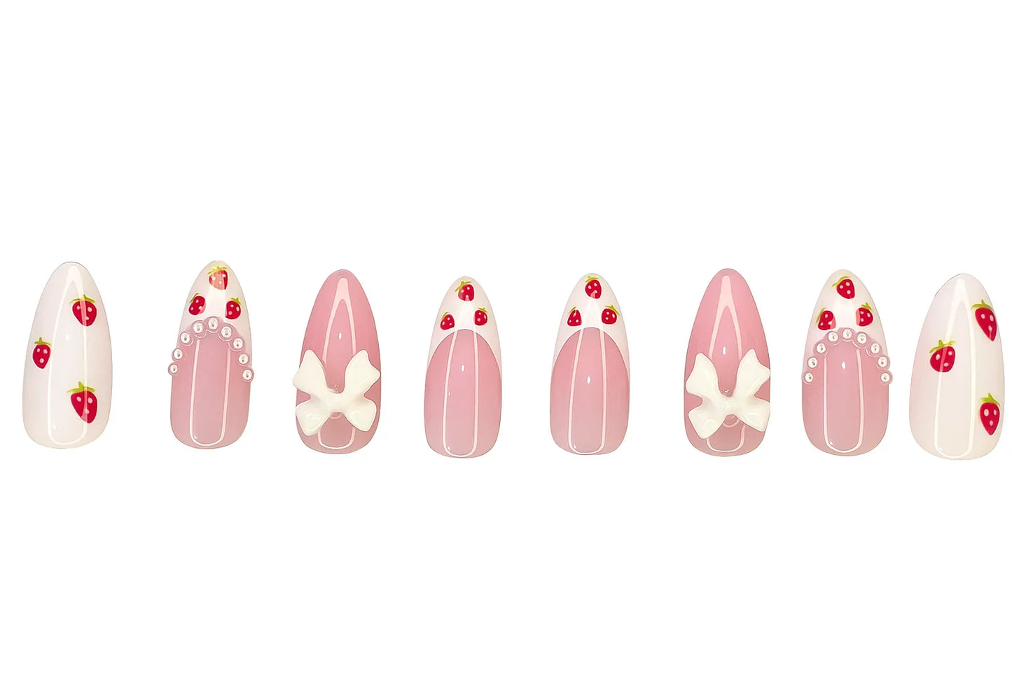 Pink and white press on nails with strawberry, bow, and pearl designs