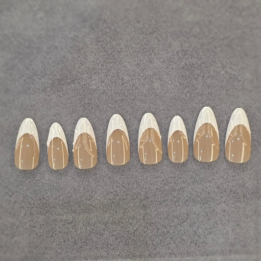 Set of glossy beige and white press-on nails with abstract swirl design on gray background