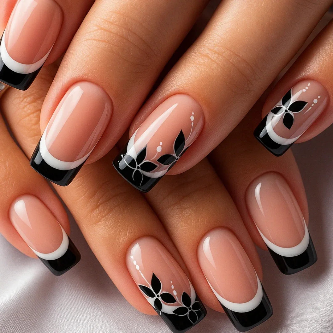 Black and white floral French tip nails with glossy finish on natural hands