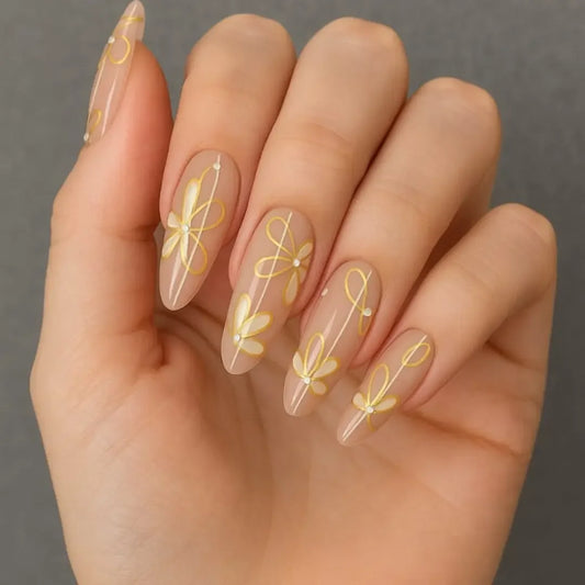 Hand with elegant nude French manicure featuring yellow daisy floral nail art.