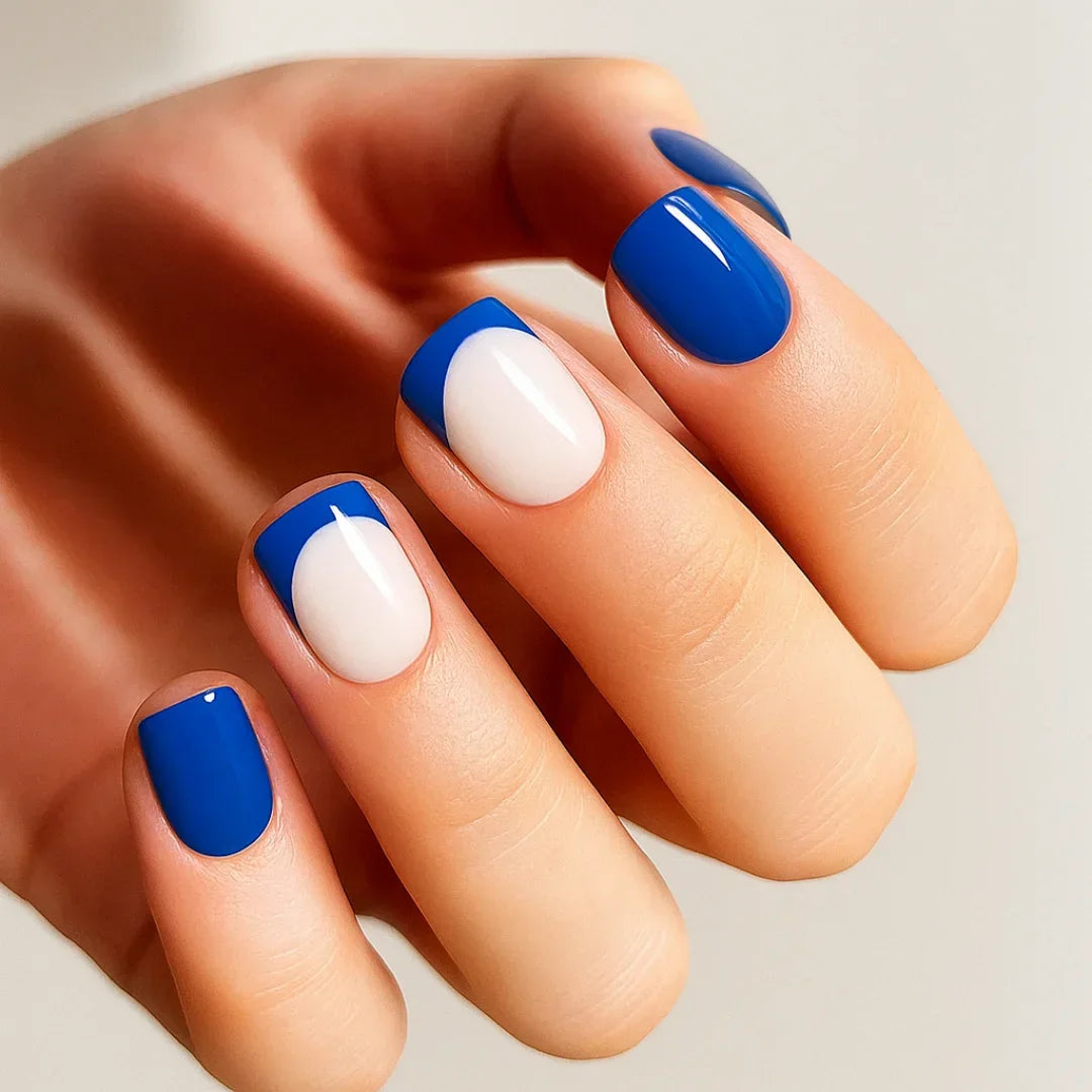 Modern blue half-moon French manicure with glossy blue and nude nail art design