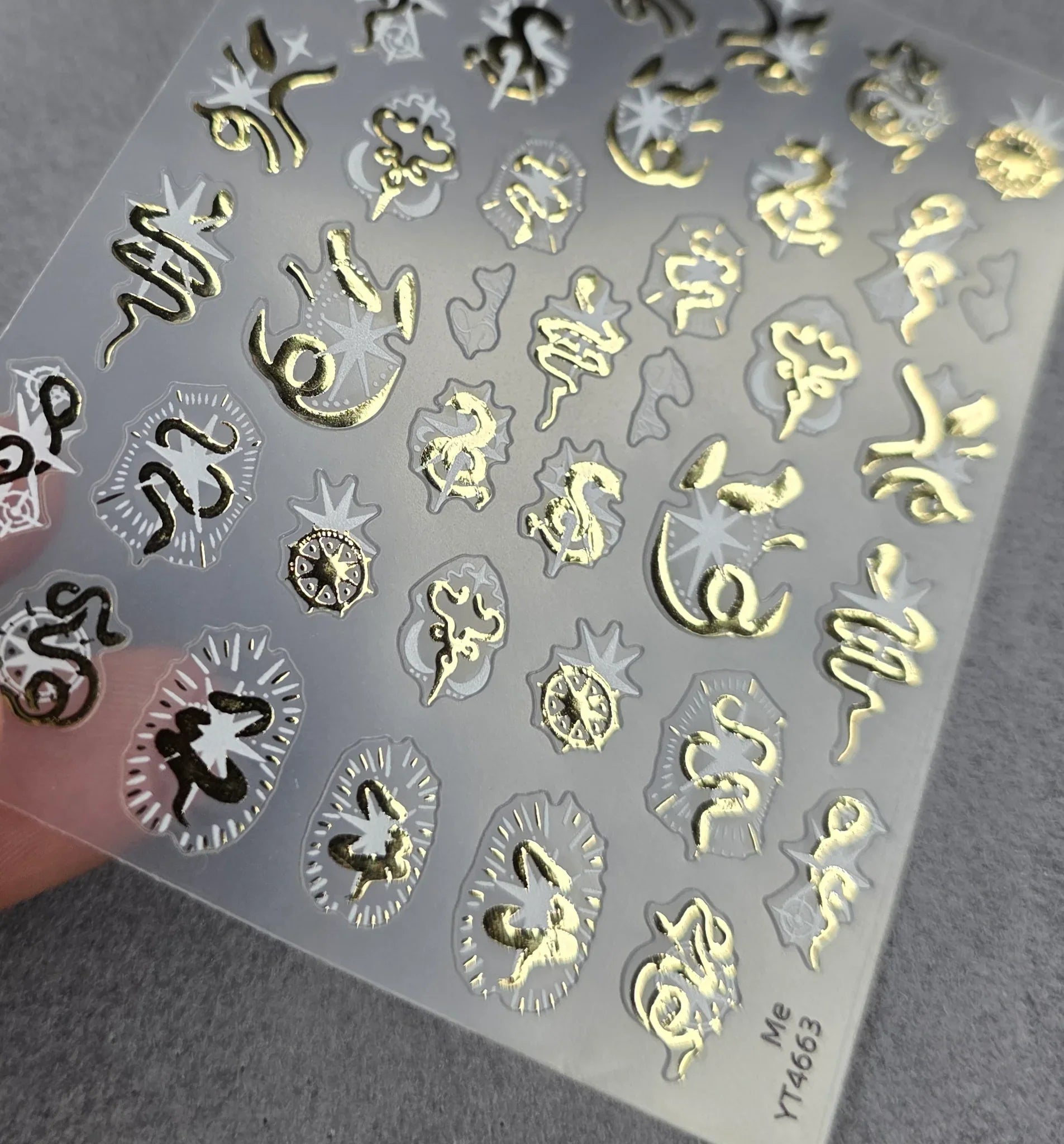 Golden foil snake nail art stickers on clear sheet for DIY manicure designs